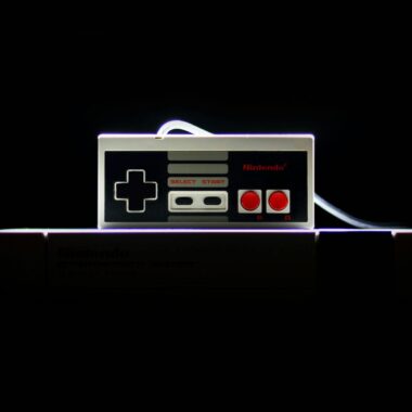 A close-up of a classic NES controller with dramatic lighting on a black background, evoking nostalgia.
