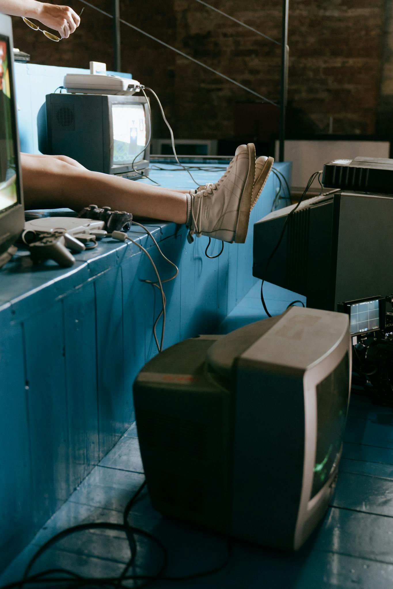 A nostalgic indoor scene of vintage video game consoles and TV screens with a focus on retro aesthetics.