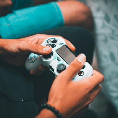 Close-up of hands holding a gaming controller, symbolizing modern gaming culture and leisure.