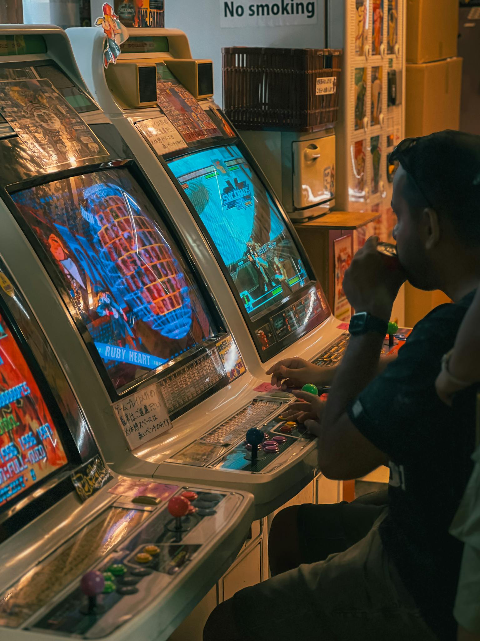 Vintage arcade gaming experience with a man playing retro video games in a classic gaming room.